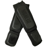Schwarze Baumwoll-Schienbeinschoner für Kampfsport und Kickboxen von Rewon, ideal für Boxtraining und Fitness-Workouts.